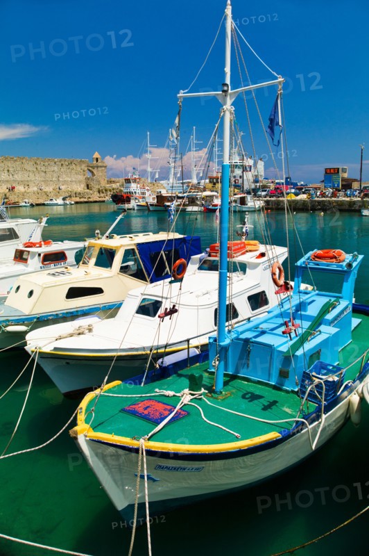 Greece, Rhodes, Harbor and old town wall.