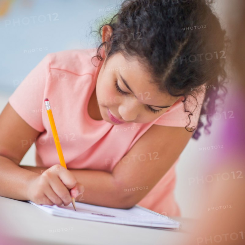 Girl (8-9) taking exam.