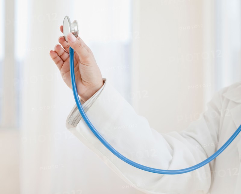Close up of female doctor's hand holding stethoscope. Photo: Jamie Grill