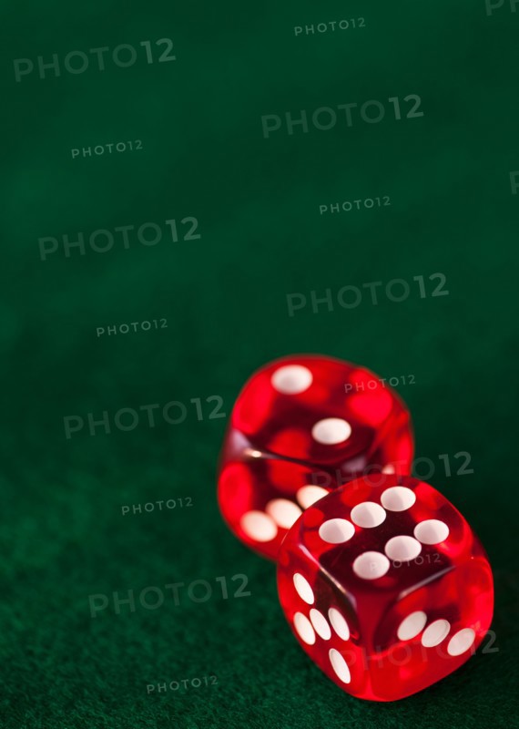 Close up of red dices on green felt. Photo: Daniel Grill