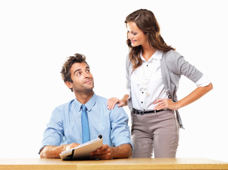 Business woman and business man reading document together. Photo : momentimages