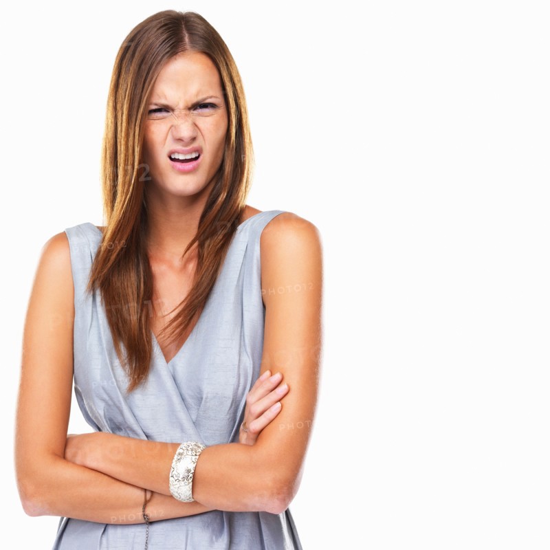 Portrait of young distressed woman standing with hands folded. Photo : momentimages