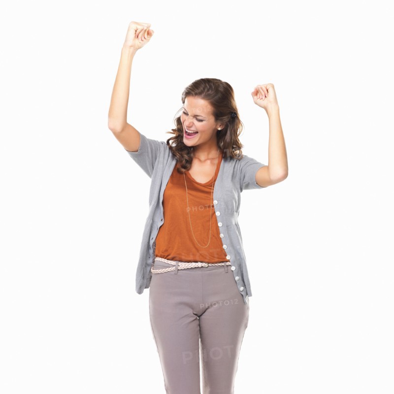 Studio portrait of excited young woman cheering. Photo : momentimages