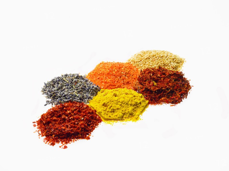 Studio shot of Piles of spice on white background. Photo : David Arky