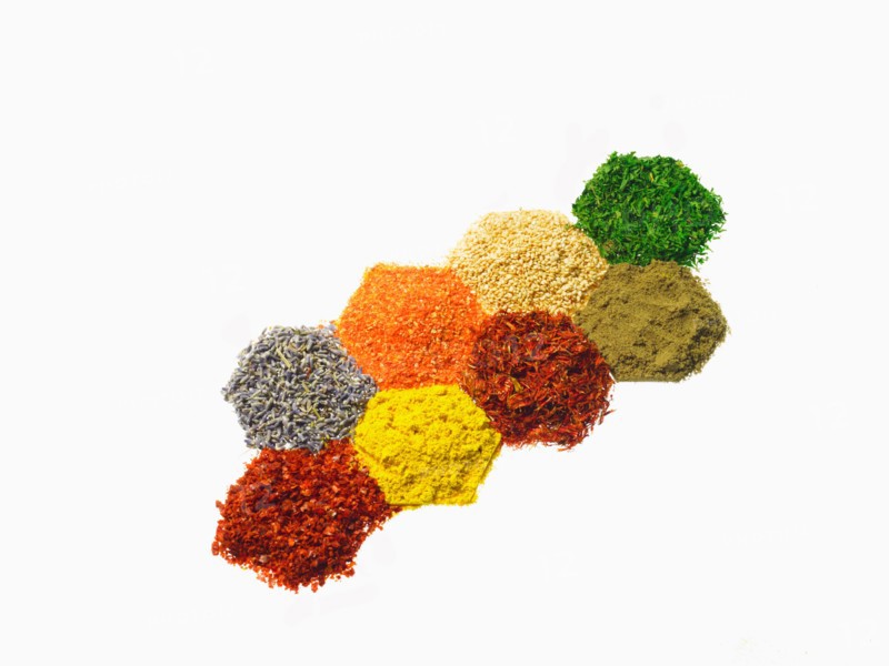 Studio shot of Piles of spice on white background. Photo : David Arky