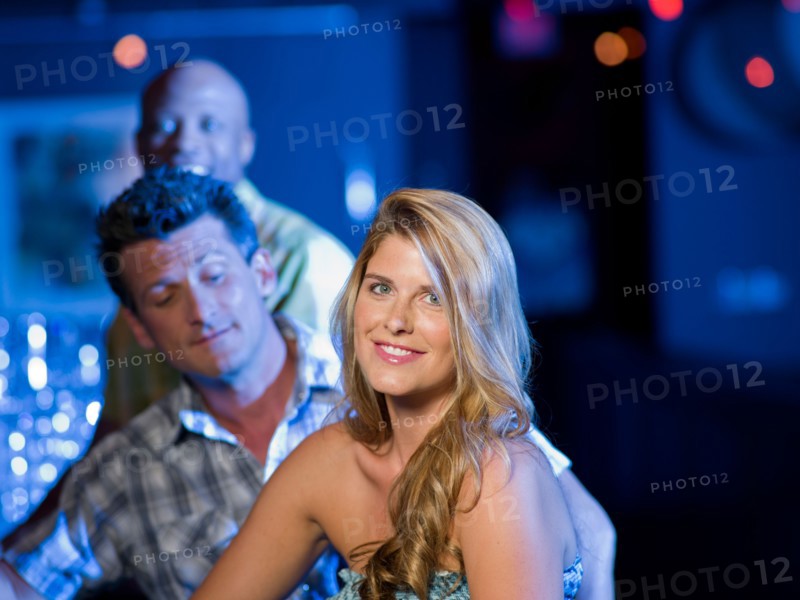 Friends enjoying drinks at bar. Photo: db2stock