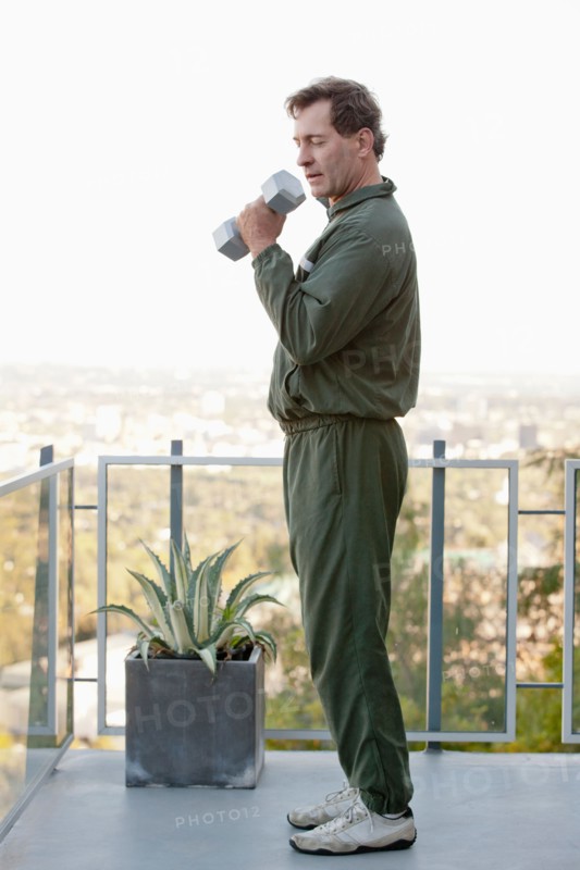 Mature man exercising on balcony. Photo: Rob Lewine
