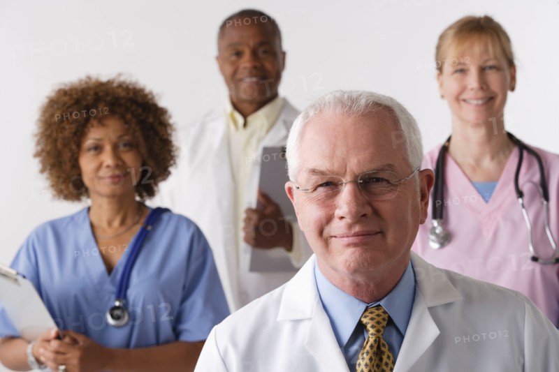 Portrait of four medical professionals, studio shot. Photo : Rob Lewine