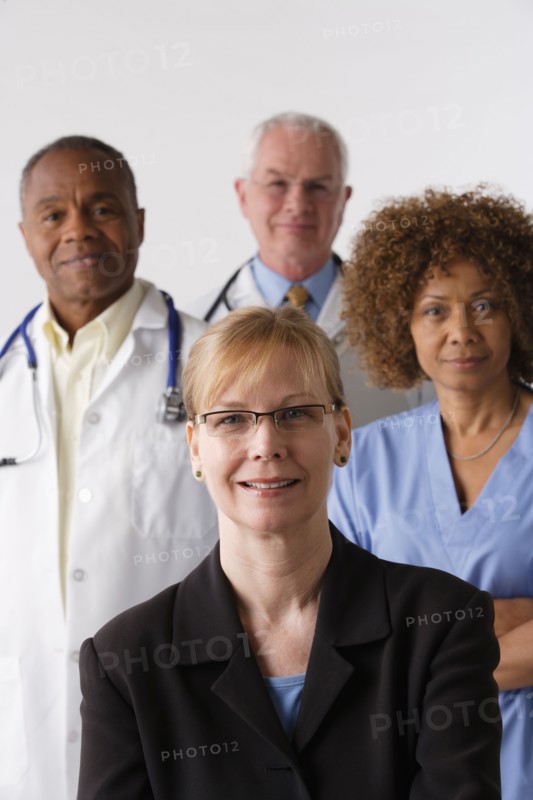 Portrait of four medical professionals, studio shot. Photo: Rob Lewine