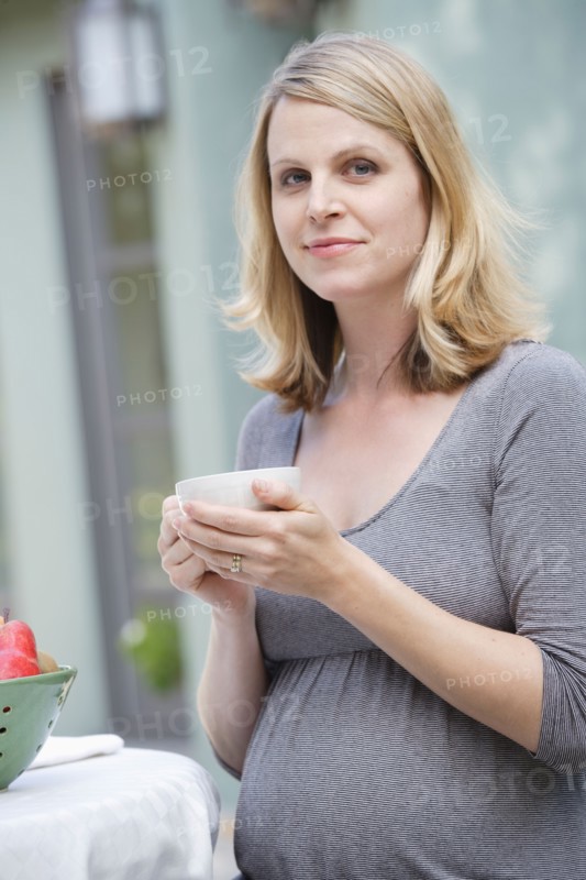 Pregnant woman enjoying cup of tea. Photo: Rob Lewine