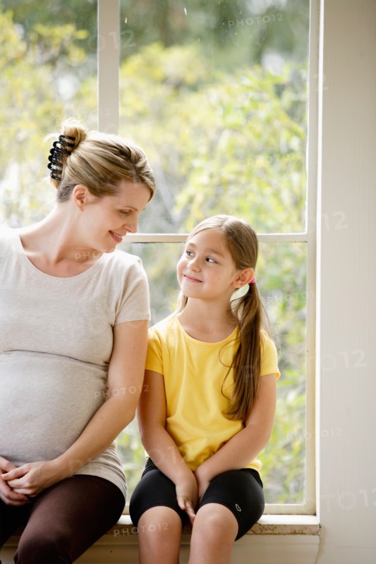 Daughter (6-7) sitting next to pregnant mother. Photo: Rob Lewine