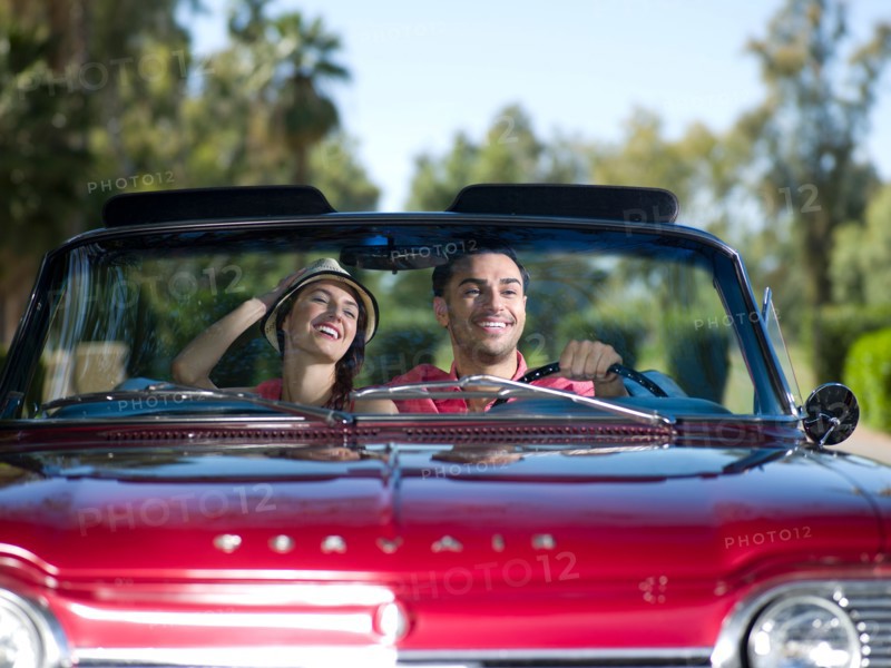 Young couple driving convertible car. Photo : db2stock
