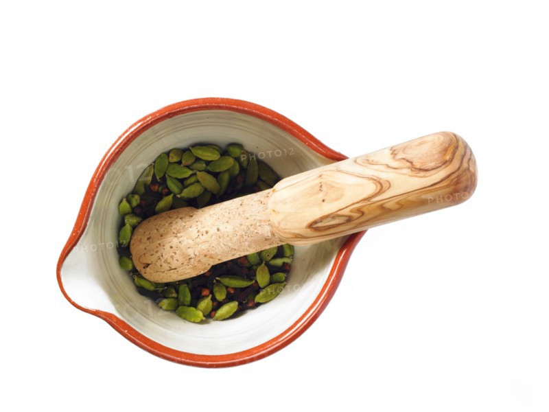 Studio shot of mortar and pestle with cardamom seeds. Photo: David Arky
