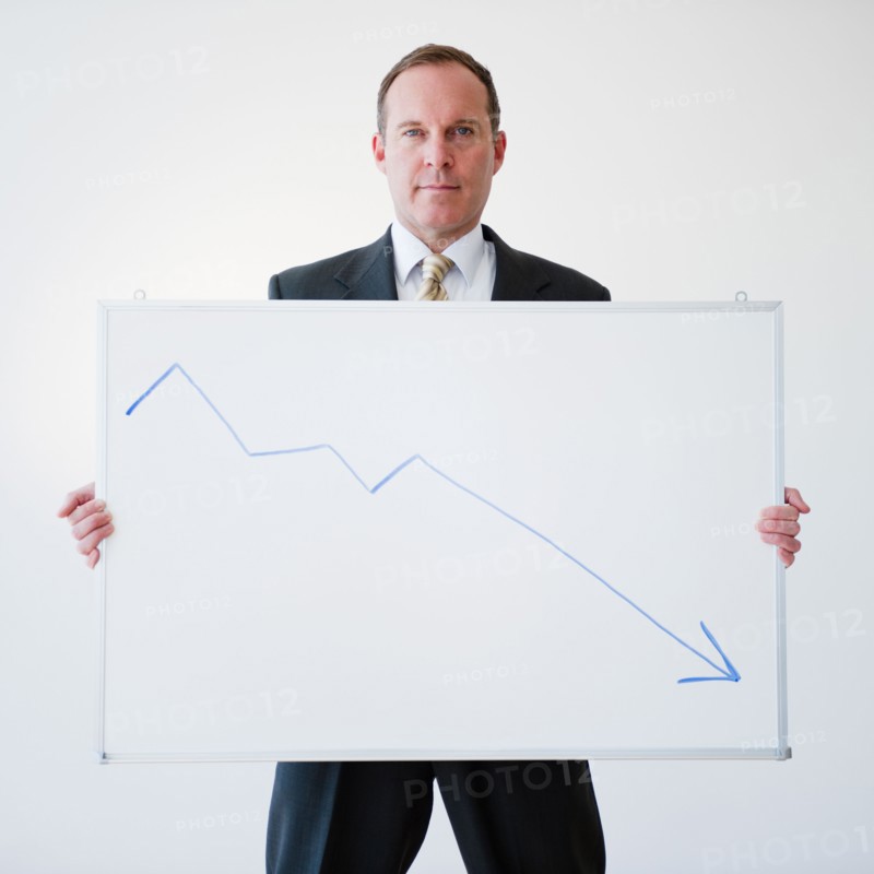 Businessman holding chart. Photo : Jamie Grill