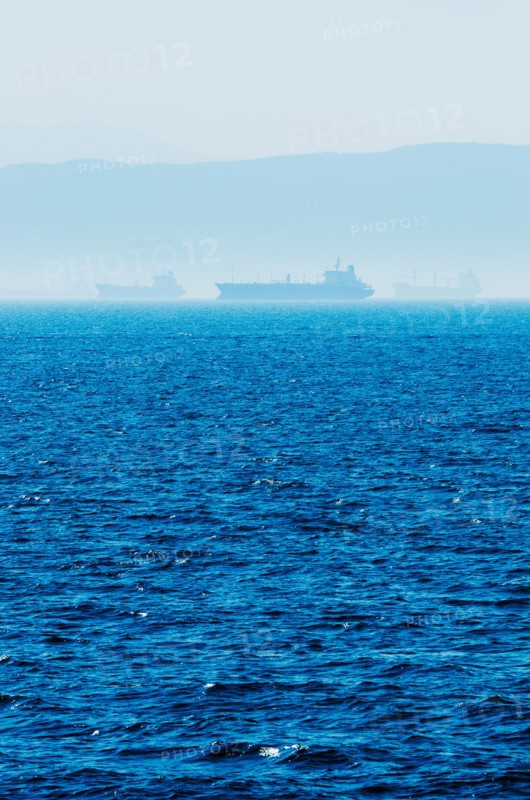 Greece, Oil tankers and cargo ships on Aegean Sea.
