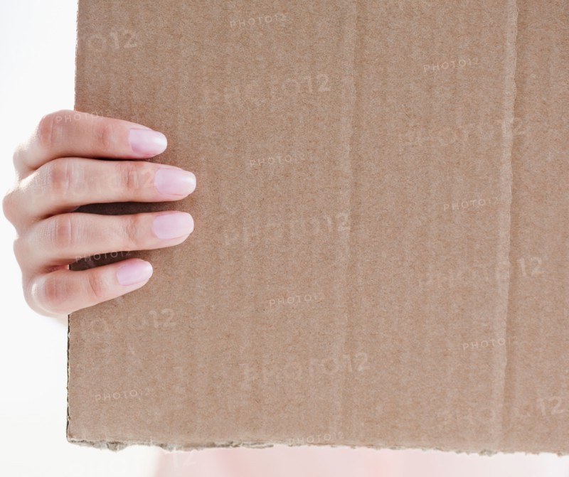 Close up of woman's hand holding cardboard. Photo: Jamie Grill