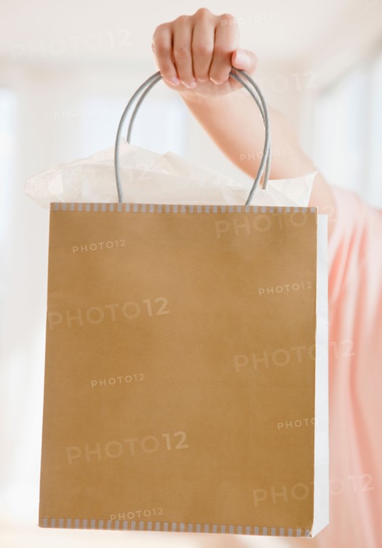 Close up of woman's hand holding shopping bag. Photo: Jamie Grill