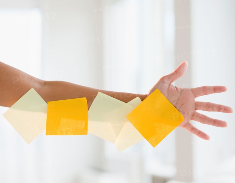 Close up of woman's hand with adhesive notes. Photo: Jamie Grill