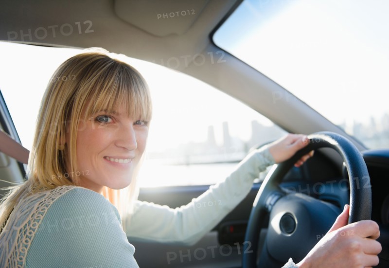 USA, Brooklyn, Williamsburg, Portrait of blonde woman driving car. Photo: Jamie Grill