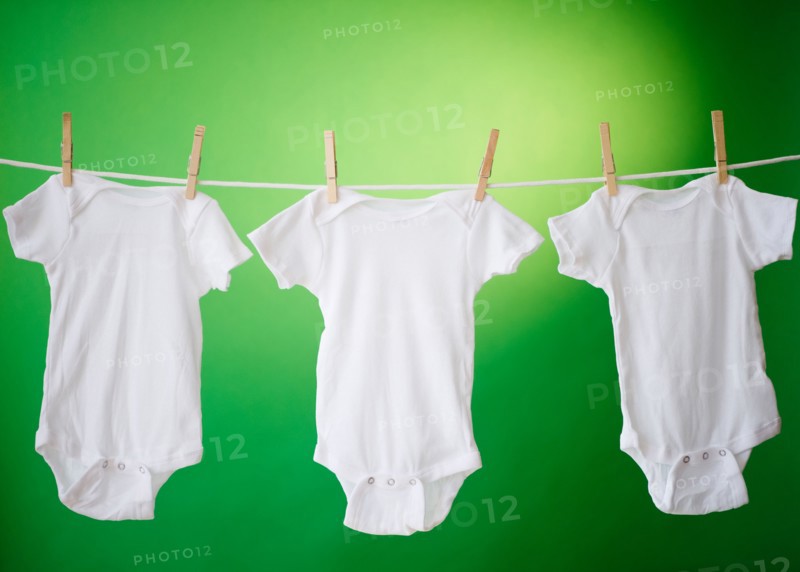 Close up of baby clothes hanging on clothesline. Photo: Jamie Grill