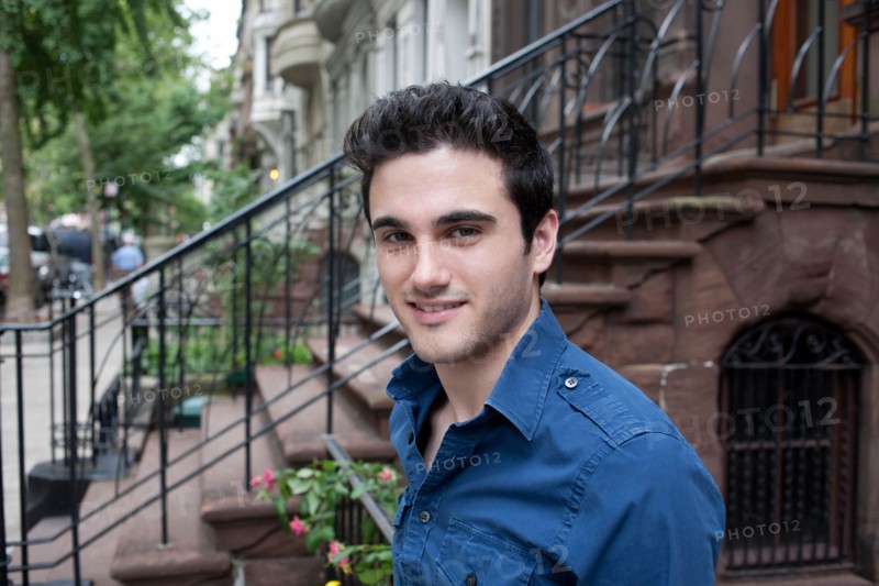 USA, New York, New York City, Portrait of smiling young man on street. Photo : Winslow Productions