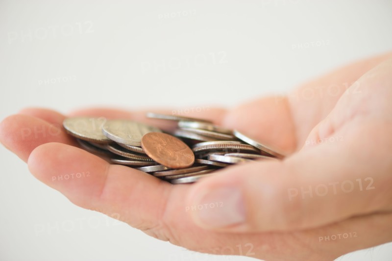 Hand holding coins.