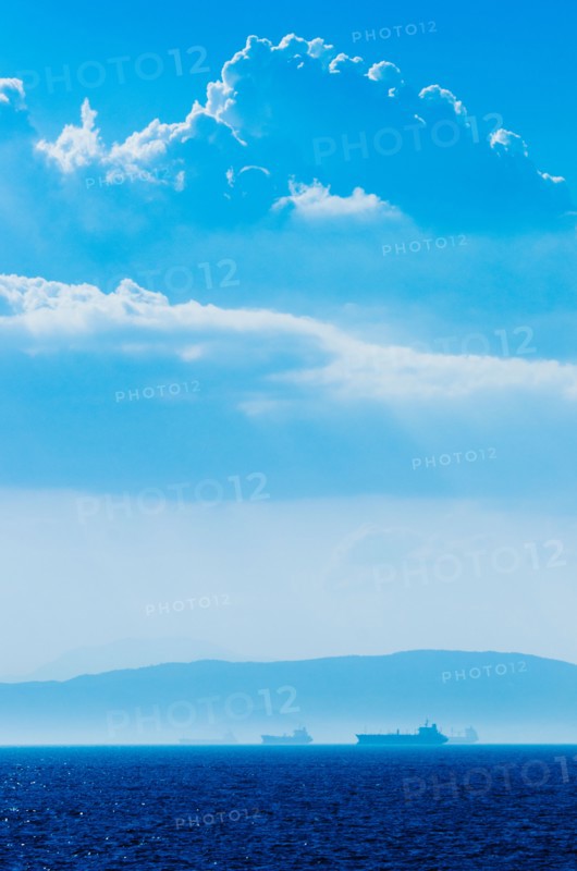 Greece, Oil tankers and cargo ships on Aegean Sea.