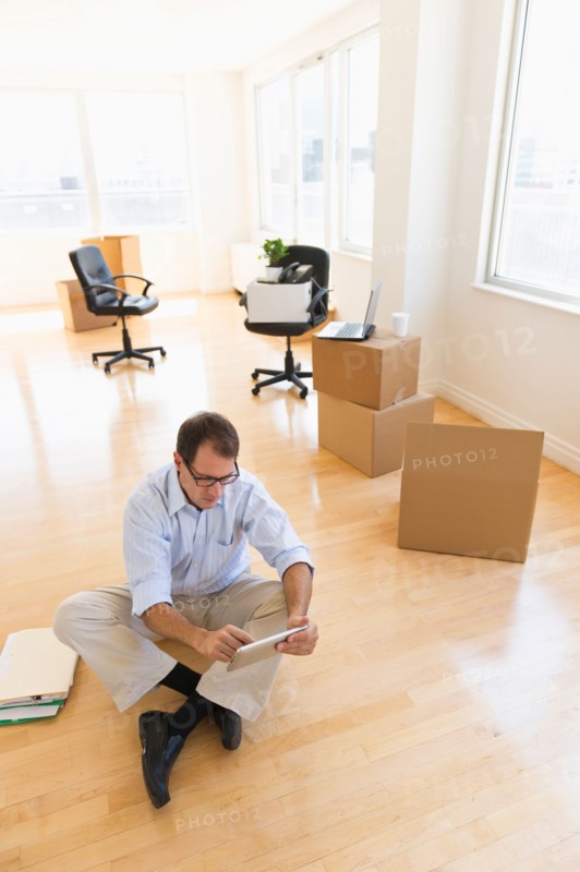 Businessman using tablet in new office.