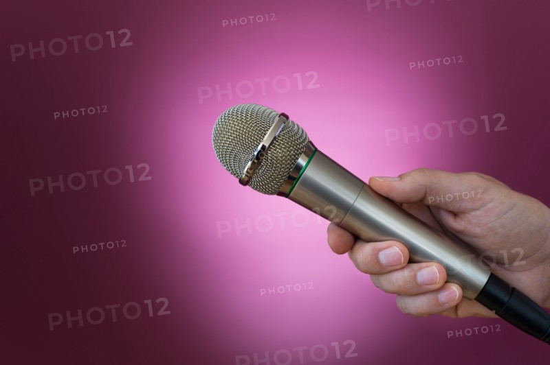 Hand holding microphone.