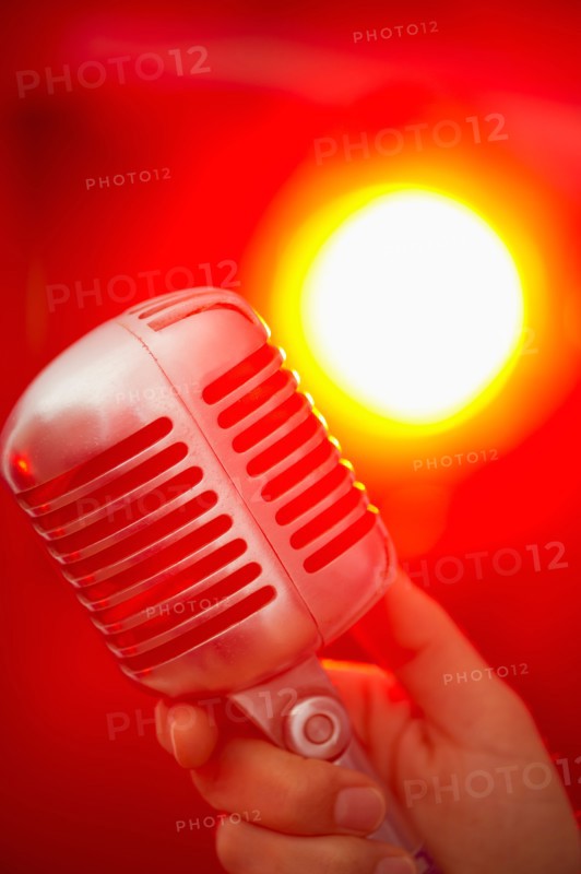 Hand holding microphone.