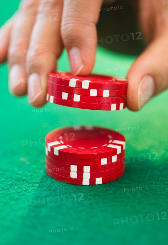 Hand handling gambling chips.