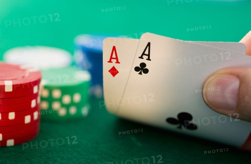 Hand holding playing cards.