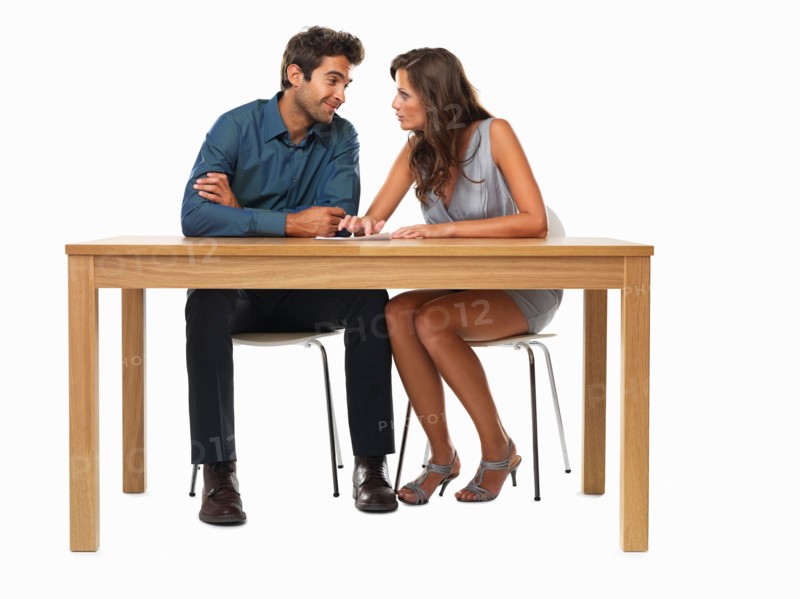 Couple sitting at table and discussing financial matter. Photo : momentimages