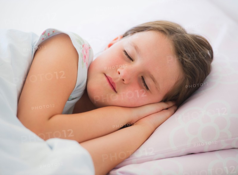 Close up of girl (6-7) sleeping in bed. Photo : Daniel Grill