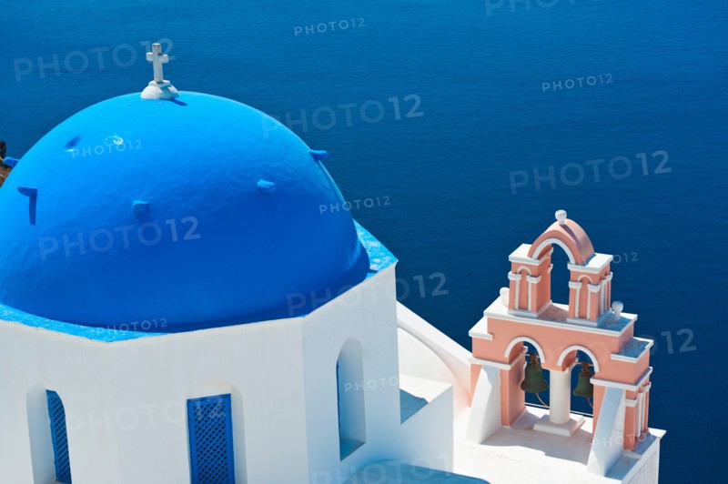 Greece, Cyclades Islands, Santorini, Oia, Church with bell tower by sea.