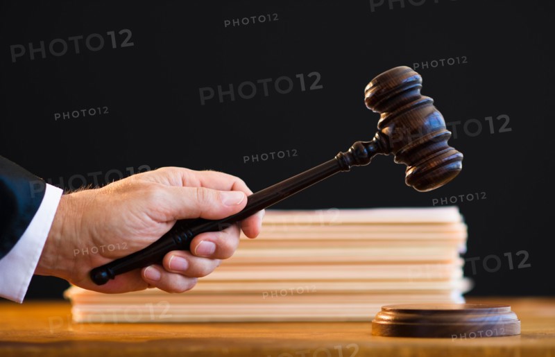 Judge holding gavel, close-up.
