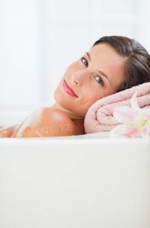 Young woman taking bath.