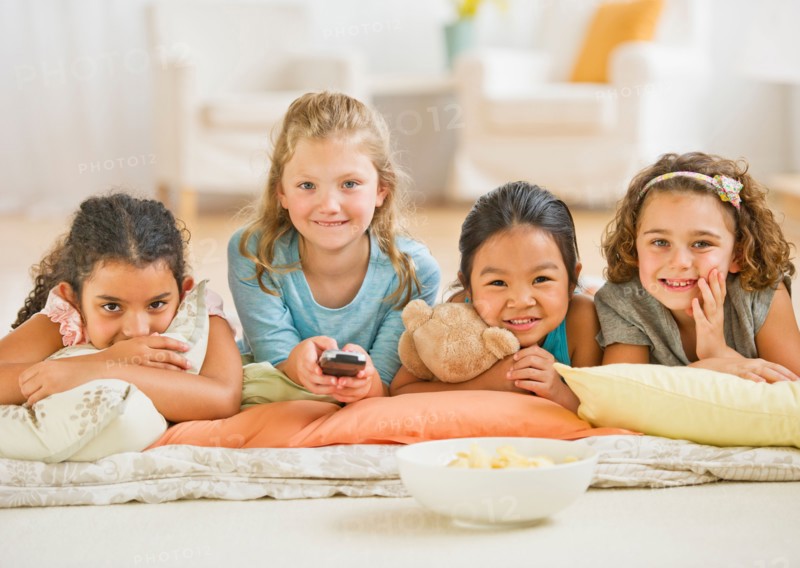Portrait of girls (6-9) watching TV.