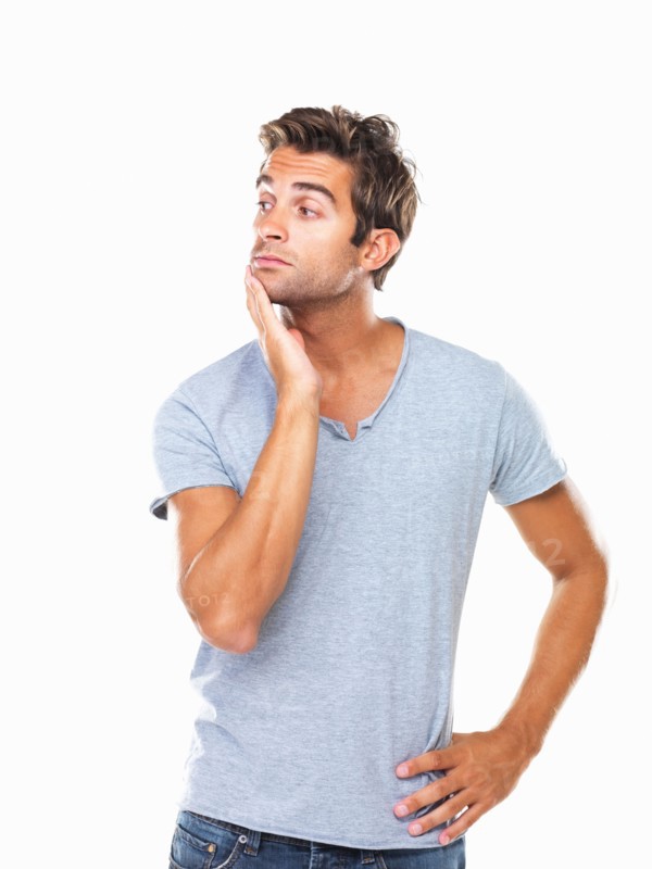 Studio shot of thoughtful young man with hand on chin. Photo: momentimages