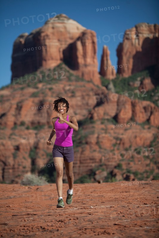 USA, Arizona, Sedona, Young woman running at desert. Photo: db2stock