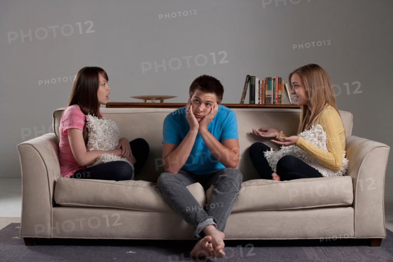 Portrait of teenage boy (16-17) and girl (16-17) with young friend. Photo : Rob Lewine