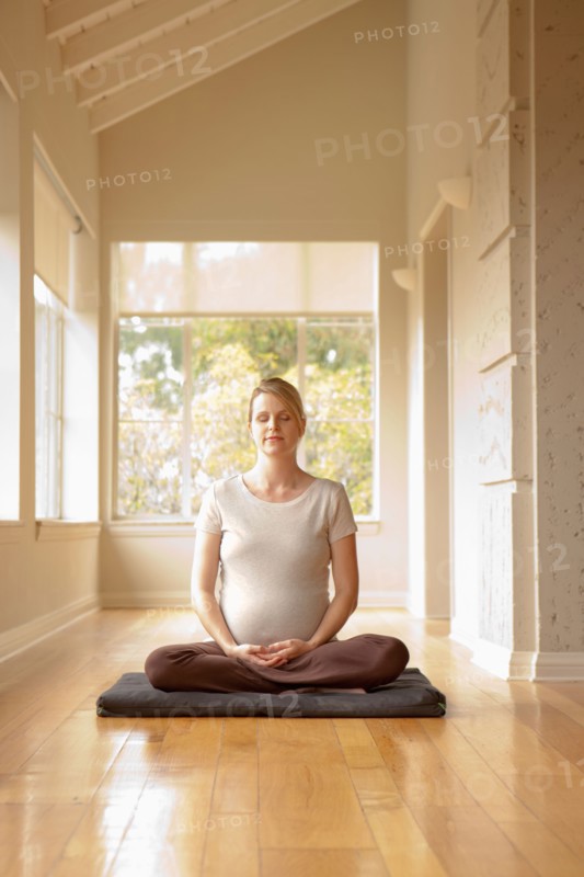Pregnant woman practicing yoga. Photo : Rob Lewine