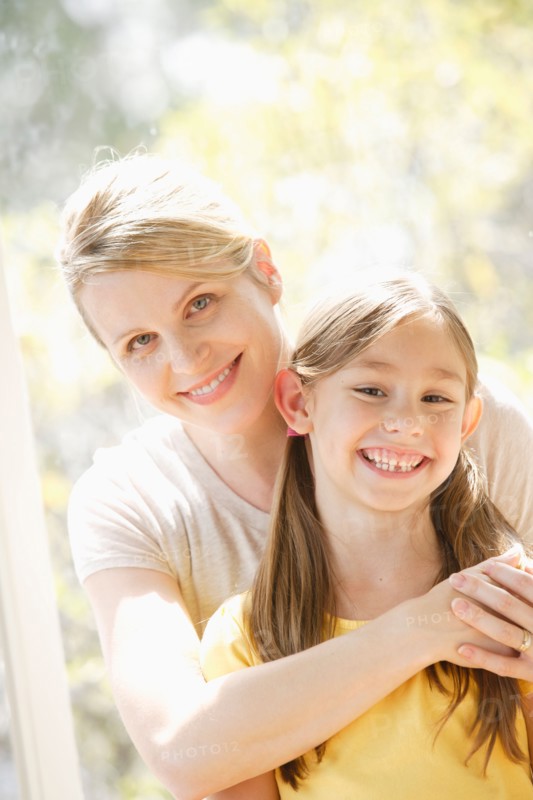 Portrait of daughter (6-7) and mother embracing. Photo: Rob Lewine