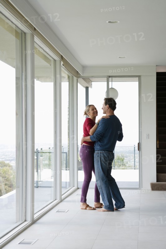 Mature couple dancing in empty living room. Photo : Rob Lewine