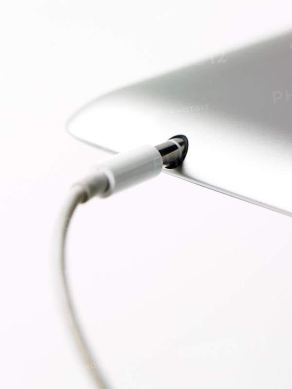 Studio shot of mobile phone with charger. Photo : David Arky