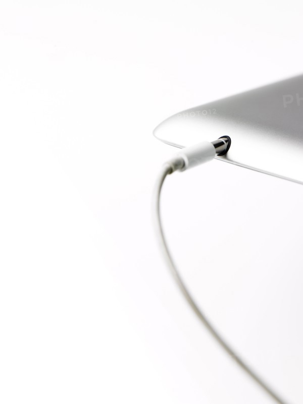 Studio shot of mobile phone with charger. Photo: David Arky
