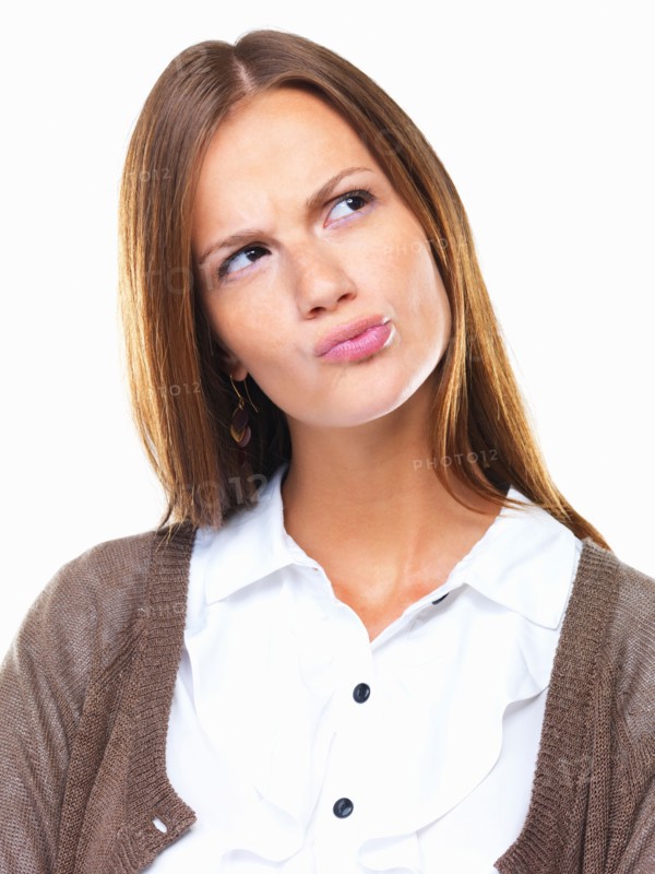 Close-up of business woman in doubt pursing her lips and looking away. Photo: momentimages