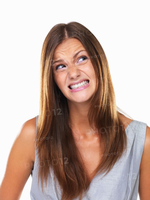 Beautiful woman with fake smile looking away. Photo: momentimages
