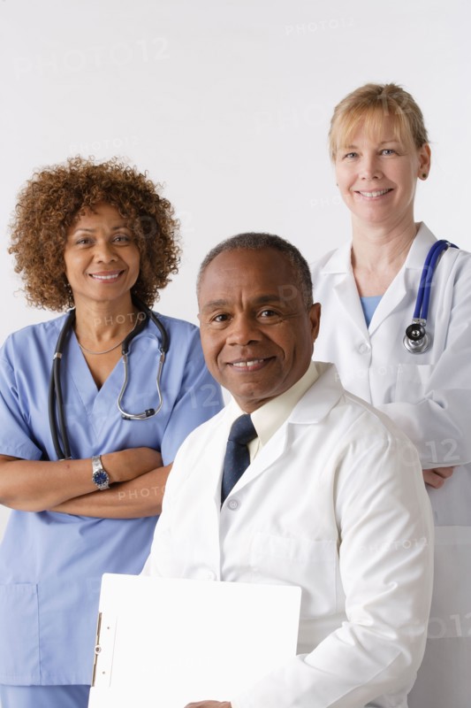 Portrait of three medical professionals, studio shot. Photo : Rob Lewine
