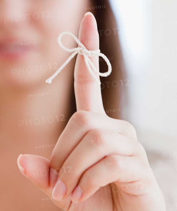 Close up of woman's finger with tied knot. Photo: Jamie Grill